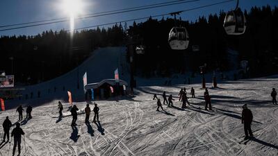 File photo: Skiers ride down a slope on December 20, 2021 at Courchevel ski resort in the French Alps. AFP