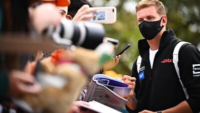 Haas driver Mick Schumacher arrives at the circuit and signs autographs for fans. Getty