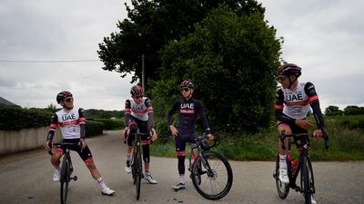 Slovenia's Tadej Pogacar centre, takes a break during a training ride with teammates. AP