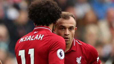 Xherdan Shaqiri speaks with Liverpool teammate Mohamed Salah before taking a free kick against Southampton. Reuters