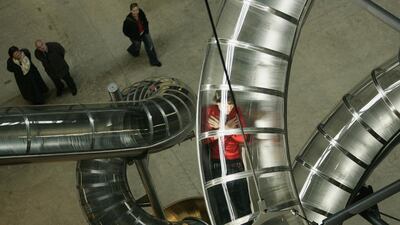 A visitor slides down artist Carsten Holler's 2006 installation entitled 'Test Site' at The Tate Modern, London. Peter Macdiarmid / Getty Images