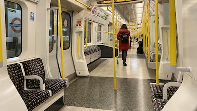 Empty seats on an early morning commuter train on the District Line, in west London, the morning after Mr Johnson announced that work-from-home guidance will return on Monday. PA