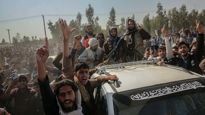 Afghans surround a vehicle of Taliban security personnel following the cross-border clashes between Pakistan and Afghanistan, in Jalalabad, Afghanistan, on Saturday. EPA