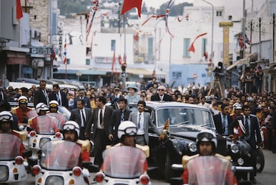 Queen Elizabeth II drives through Tunis with Tunisian President Habib Bourguiba during a State Visit to Tunisia in October 1980. Getty