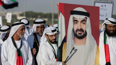 Tribe members carry a portrait of President Sheikh Mohamed.