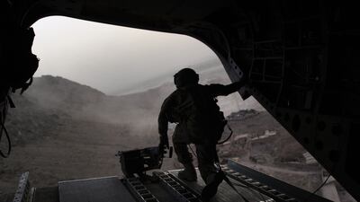 In this file photograph taken on July 29, 2011, a US soldier mans a machine gun on a US military Chinook helicopter as it heads to Kandahar military base while transporting troops around southern Afghanistan.