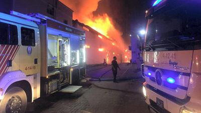 Firefighters tackle a blaze at four warehouses in Ajman. Courtesy Ajman Civil Defence