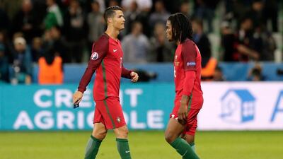 Portugal's Cristiano Ronaldo, left, and Renato Sanches react at the end of the Euro 2016 Group F match against Iceland at the Geoffroy Guichard stadium in Saint-Etienne, France, Tuesday, June 14, 2016. (AP Photo/Pavel Golovkin)
