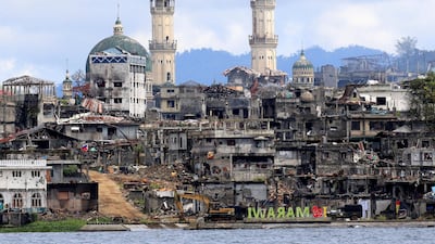 A signage of 'I love Marawi' is seen in front of damaged houses, buildings and a mosque inside a war-torn Marawi city in the Philippines. Romeo Ranoco / Reuters