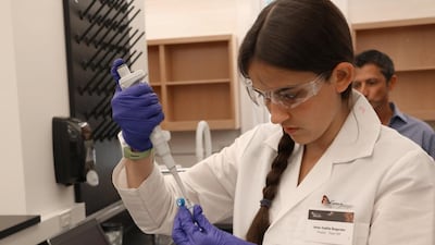 Anna-Sophia Boguraev collects DNA samples using a mini PCR machine. James McNeill