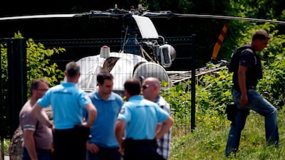French police stand near a helicopter abandoned in Gonesse, north of Paris, by armed robber Redoine Faid after he used it to escape from a prison in Reau on July 1, 2018. Geoffroy Van Der Hasselt / AFP