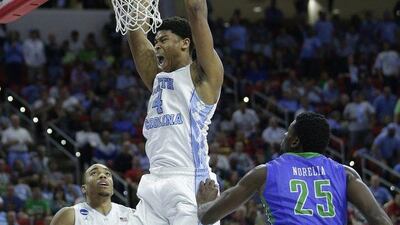 North Carolina forward Isaiah Hicks (4) dunks the ball by Florida Gulf Coast forward Marc Eddy Norelia (25) during the second half of a first-round men's college basketball game in the NCAA Tournament, Thursday, March 17, 2016, in Raleigh, N.C. (AP Photo/Chuck Burton)