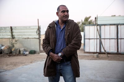 Jaber Abu Queder 51, head of local council of the unrecognised village of Al-Zarnoug outside his home in the early evening. Heidi Levine for The National.