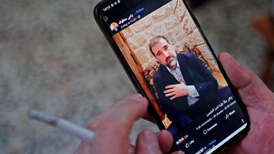 A man watches a Facebook video posted by Syrian businessman Rami Makhlouf in Damascus on May 11, 2020. AFP