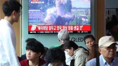 A TV screen shows file footage of the demolition of the 60-foot-tall cooling tower at its main reactor complex in Yongbyon, North Korea. AP