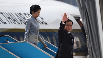 Thailand's prime minister Prayut Chan-O-Cha, right, arrives with his wife Naraporn. Ye Aung Thu / AFP Photo