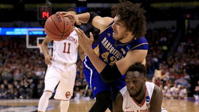 OKLAHOMA CITY, OKLAHOMA - MARCH 18: Aly Ahmed #42 of the Cal State Bakersfield Roadrunners with the ball against Khadeem Lattin #12 of the Oklahoma Sooners in the second half in the first round of the 2016 NCAA Men's Basketball Tournament at Chesapeake Energy Arena on March 18, 2016 in Oklahoma City, Oklahoma. Tom Pennington/Getty Images/AFP== FOR NEWSPAPERS, INTERNET, TELCOS & TELEVISION USE ONLY ==