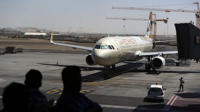 Etihad Airways passengers wait to board a flight at Abu Dhabi International Airport. Delores Johnson / The National