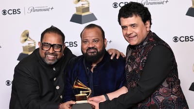 Shakti members, from left, Shankar Mahadevan, Selvaganesh Vinayakram and Ganesh Rajagopalan celebrate their Grammy win. EPA