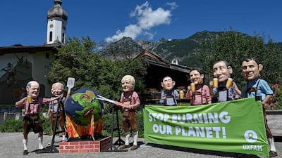 Protesters dressed as the G7 leaders hold up a banner near the summit venue in southern Germany. AFP