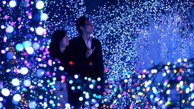 People look at Christmas illuminations and decorations in Tokyo, Japan. Christmas Eve surpasses Valentine's Day as the romantic dinner event for Japanese couples. Kiyoshi Ota / Bloomberg