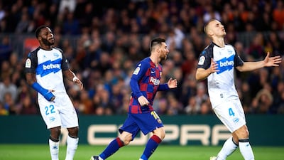 Messi celebrates scoring his team's third goal during the La Liga match against Deportivo Alaves in December. Getty