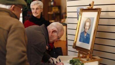 Visitors sign a condolence book for the former British prime minister Margaret Thatcher in Grantham, central England.