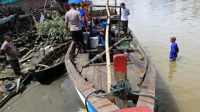 Police officers inspect a boat that was carrying Rohingya men who were rescued by local fishermen in Kuala Idi, Aceh province, Indonesia, Tuesday, Dec. 4, 2018. Associated Press