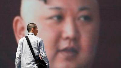 A man walks past a an image North Korea's leader Kim Jong Un. Trade with neighbouring China has plummeted. Toru Hanai / Reuters