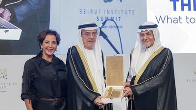 Zaki Nusseibeh, Minister of State, receives an award of recognition from the Beirut Institute, presented by Raghida Dergham, founder of Beirut Institute, left, and Saudi Arabia’s Prince Turki Al Faisal . Beirut Institute