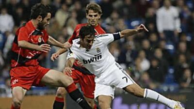 Real Madrid's Raul, in white, fights for the ball with Real Union's Gurrutxaga during their Copa del Rey clash.