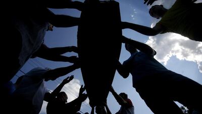 Bosnian Muslims carry coffins with bodies from a mass grave, before a mass funeral in Kozarac, near Prijedor. Dado Ruvic / Reuters