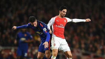 Mikel Arteta, right, of Arsenal is tackled by Robin van Persie of Manchester United during their Premier League match at Emirates Stadium on November 22, 2014 in London, England. (Photo by Michael Regan/Getty Images)