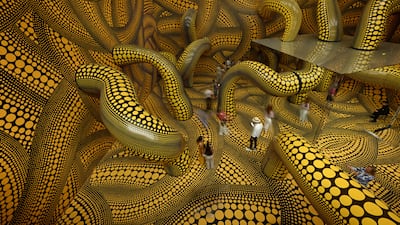 Visitors walk through an installation by Kusama at the Museum Ludwig in Cologne. AFP