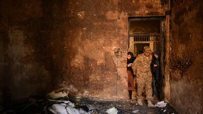 A Pakistani soldier shows the media a burnt classroom at an army-run school on December 17, the day after an attack by Pakistani Taliban militants which left 148 people dead. A Majeed/AFP Photo