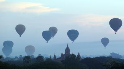 Hot air balloons fly over the Myanmar's old temple just before sunrise in Bagan, Nyaung U district, central Myanmar. AP Photo