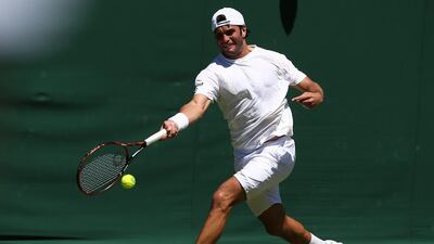 Tunisia's Malek Jaziri returns to Australia's James Duckworth during their men's singles first round match at the All England Club in Wimbledon, southwest London, on June 30, 2015. AFP PHOTO / JUSTIN TALLIS