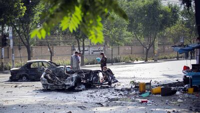 Security officials inspect the scene of the bomb blast. EPA