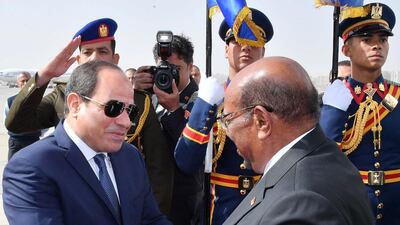 Egyptian President Abdel Fatah El Sisi greets Sudanese President Omar Al Bashir at Cairo airport during a visit on January 27, 2019. Egyptian Presidency via Reuters