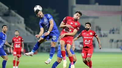 Shabab Al Ahli's Carlos Euardo battles with Al Nasr's Tozé Carvalho. Chris Whiteoak / The National
