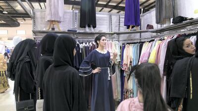 Jameela Ahmed, 23, from Morocco, sells jalabiyas at Ras Al Khaimah's Eid Al Adha fair. Reem Mohammed / The National