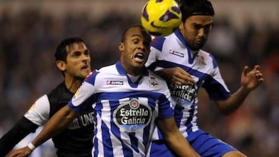 Deportivo Coruna's Brazilian defender Evaldo (C) and Colombian midfielder Abel Aguilar (R) jump for the ball with Malaga's Paraguayan forward Roque Santa Cruz (L) during the Spanish league football match RC Deportivo de la Coruna vs Malaga CF at the Municipal de Riazor stadium in La Coruna on January 5, 2013. AFP PHOTO/ MIGUEL RIOPA *** Local Caption *** 201634-01-08.jpg