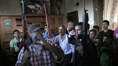 Saed Abu Aser, center right, dances with relatives while holding guns in the family house during his wedding party, in Gaza City.