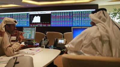 Many of Qatar’s publicly listed companies have a foreign ownership limit of 25 per cent, although some have lifted these of late. Above, traders at Qatar's stock exchange. Mohammed Dabbous / Reuters