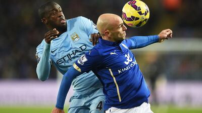 Yaya Toure of Manchester City and Esteban Cambiasso of Leicester City compete for a header during their Premier League match on Saturday. Michael Regan / Getty Images