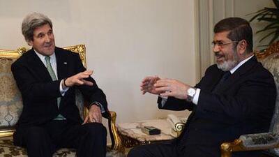 John Kerry, the US secretary of state, left, meets Egypt's president, Mohammed Morsi, at the presidential palace in Cairo on Sunday. Khaled Desouki / AFP
