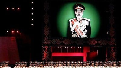 Omani soldiers parade under a picture of Omani ruler Sultan Qaboos bin Said during celebrations marking 40 years since he took the throne.