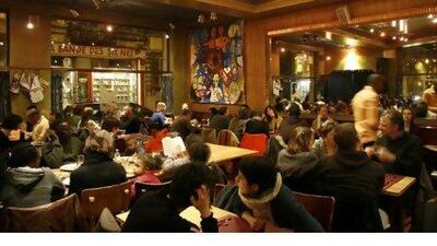 A full house at L´Horloge du Sud restaurant in Matonge, the city's African quarter. Below, a cornet of frites, the ubiquitous snack of Brussels. Photographs by John Brunton for The National