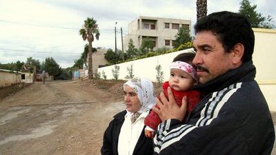 Abdalla el Bechnaoui and his wife Jamila Aarrach with their daughter, Tiziri, in Zerarda. John Thorne / The National