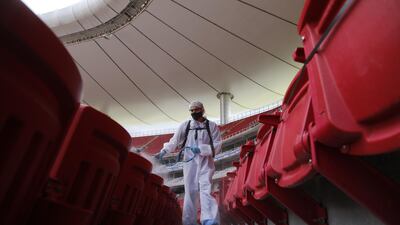 Workers spray disinfectant in the seating area prior to the match between Chivas de Guadalajara and Pachuca in the Guardians 2020 tournament at the Akron Stadium in Guadalajara, Jalisco, Mexico. EPA